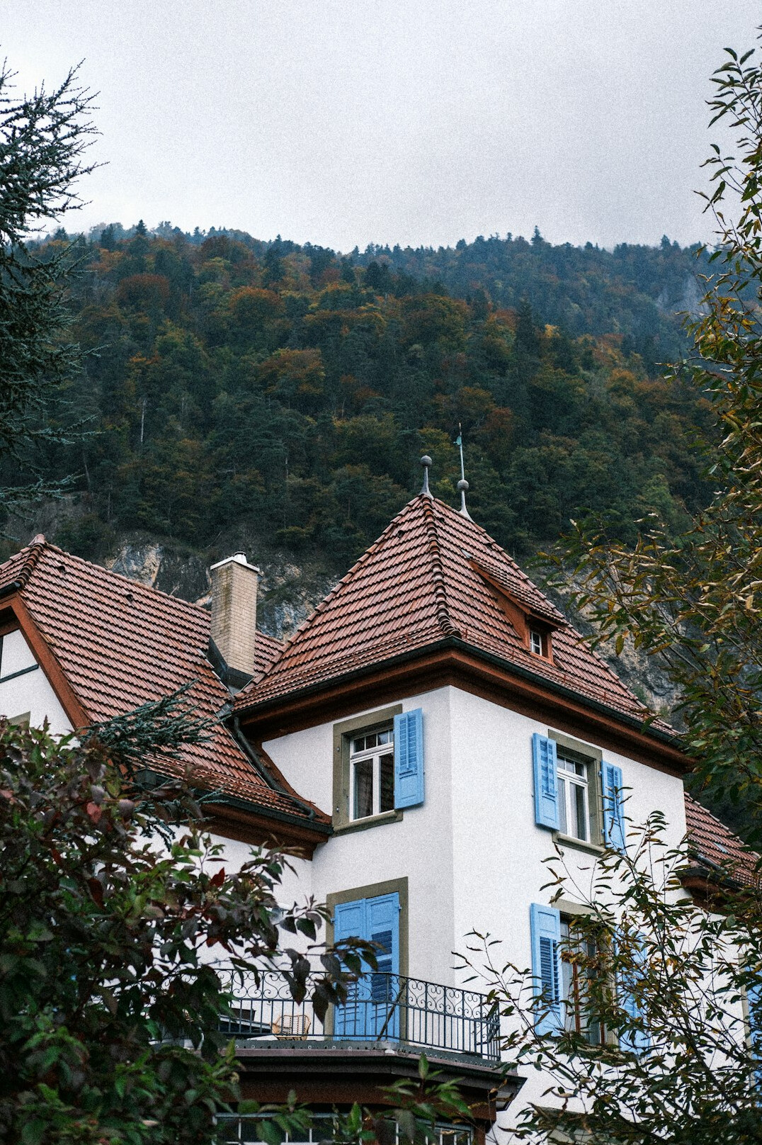 Luxurious villa facade in the Swiss Alps surrounded by pine trees