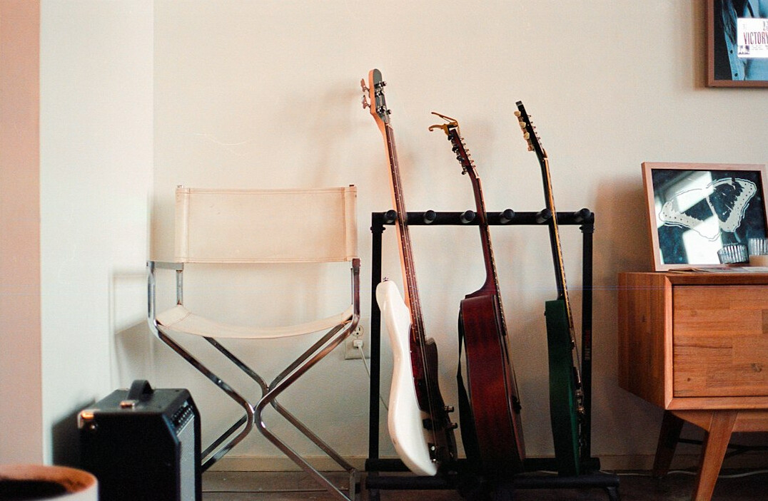 Musician home studio with vinyl records and guitars on the wall