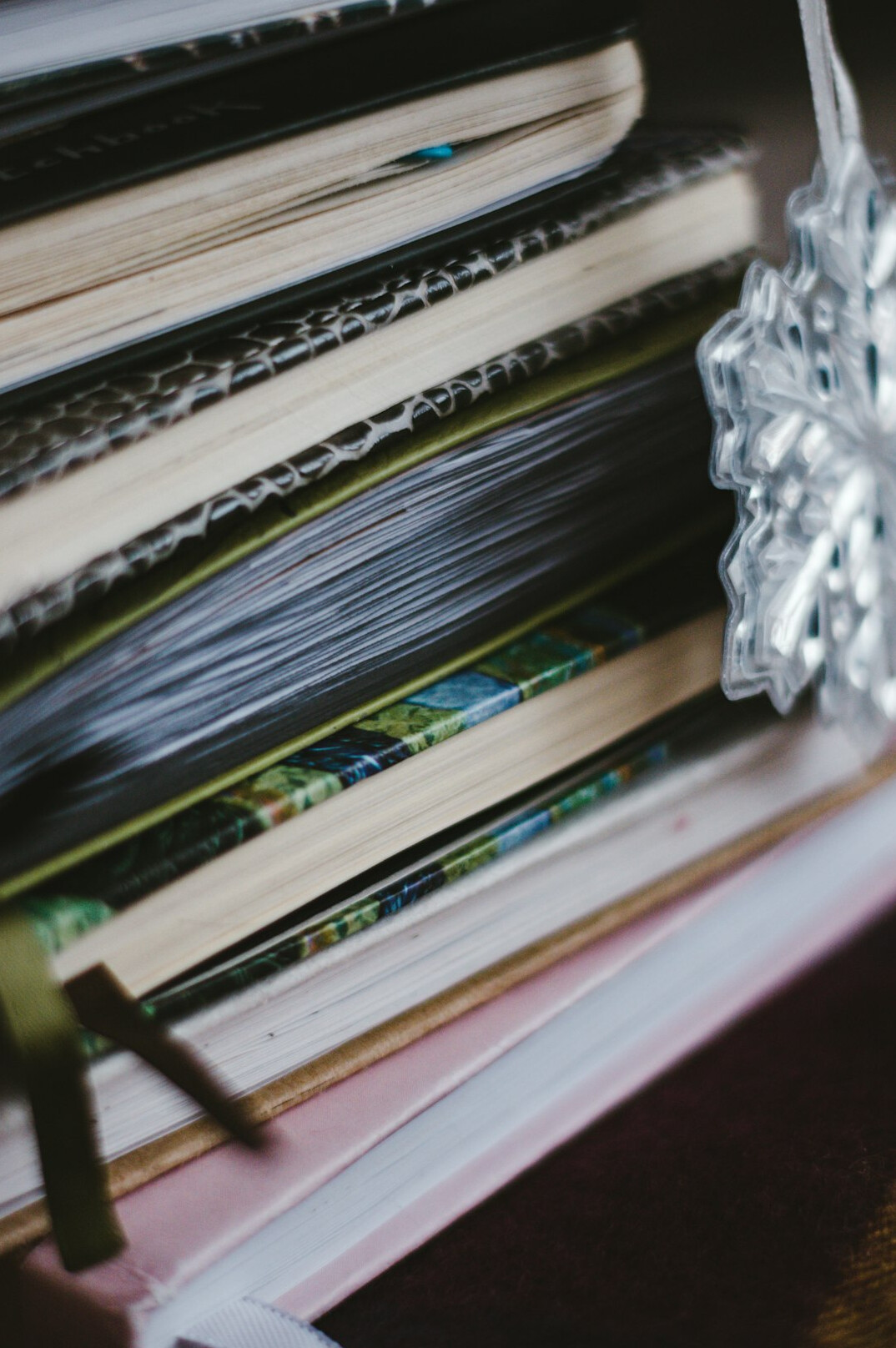 Stack of archive magazines and photo albums on a wooden table